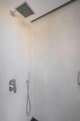 a bathroom with a shower in a wall at Penthouse with views close to Monastiraki metro in Athens