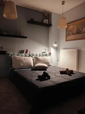 a bedroom with a large bed with two objects on it at Rsquared (Riviera Residence) in Aghia Marina