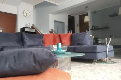 a living room with a blue couch and a table at Rsquared (Riviera Residence) in Aghia Marina