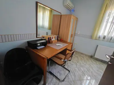 an office with a desk with two chairs and a mirror at Rsquared (Riviera Residence) in Aghia Marina