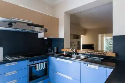 a kitchen with blue cabinets and a sink at Elegant Maisonette 4BD Glyfada in Athens