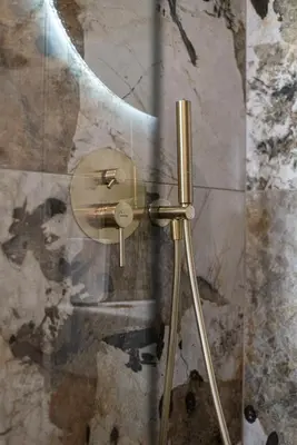 a shower with a glass door in a bathroom at Two Bedroom Sea View Apartment in Glyfada Beach in Athens