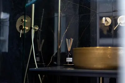 a table with a gold bowl on top of it at Two Bedroom Sea View Apartment in Glyfada Beach in Athens