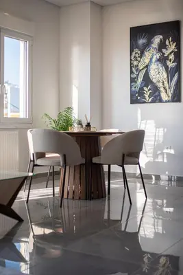a dining room with a table and two chairs at Two Bedroom Sea View Apartment in Glyfada Beach in Athens