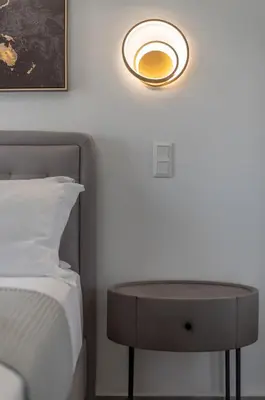 a bedroom with a bed and a table next to a bed at Two Bedroom Sea View Apartment in Glyfada Beach in Athens