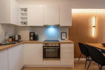 a kitchen with white cabinets and a stove at Chic and Lavish Apartment in Athens in Athens