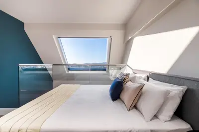 a large bed in a room with a window at Exceptional Living Lofts by UPSTREET in Athens