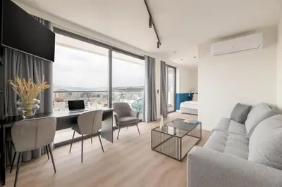 a living room with a couch and a table with a laptop at Exceptional Living Lofts by UPSTREET in Athens