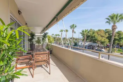 a balcony with two benches and a view of the ocean at The HostMaster Beachside Retreat in Vari