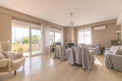 a large living room with tables and chairs and windows at The HostMaster Beachside Retreat in Vari