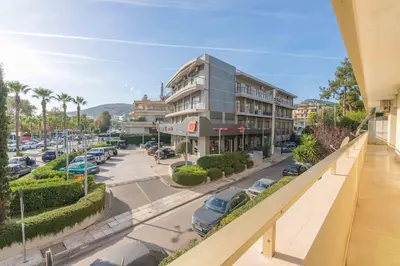 a building on a street with a parking lot at The HostMaster Beachside Retreat in Vari