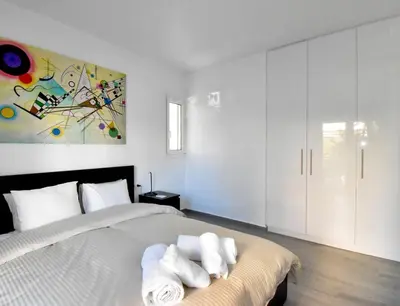 a bedroom with a bed with two towels on it at Glyfada Maisonette by Taurus in Athens