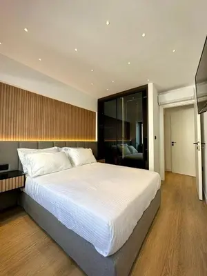 a bedroom with a large bed with white sheets at BlueMotion - CruiseHub 1B in Piraeus