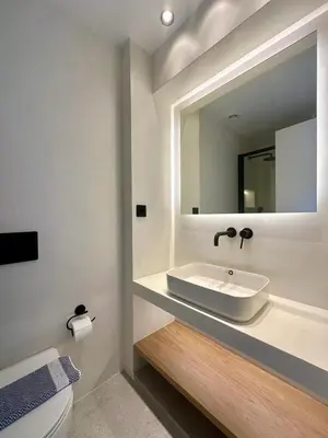 a bathroom with a sink and a mirror at BlueMotion - CruiseHub 1B in Piraeus