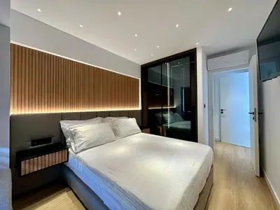 a bedroom with a large white bed in a room at BlueMotion - CruiseHub 1B in Piraeus