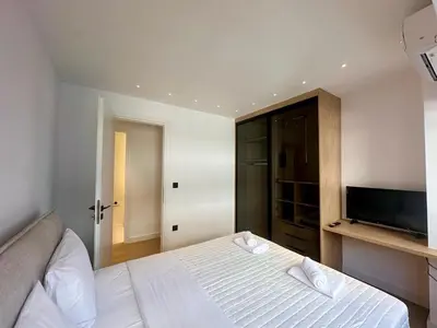 a bedroom with a bed and a flat screen tv at BlueMotion - CruiseHub 2B in Piraeus