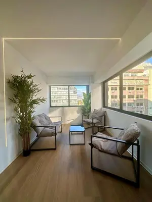 a living room with two chairs and a table at BlueMotion - CruiseHub 2B in Piraeus