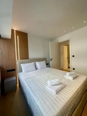 a bedroom with a large bed with two towels on it at BlueMotion - CruiseHub 2B in Piraeus