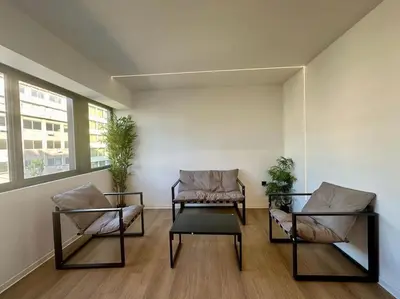 two chairs and a coffee table in a room at BlueMotion - CruiseHub 3B in Piraeus
