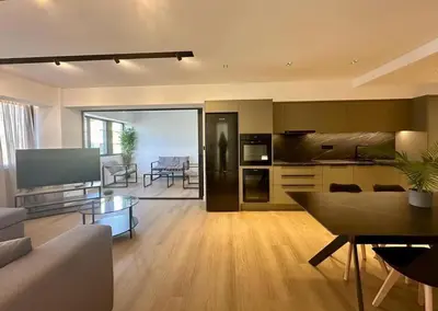 a living room with a kitchen and a dining room at BlueMotion - CruiseHub 3B in Piraeus