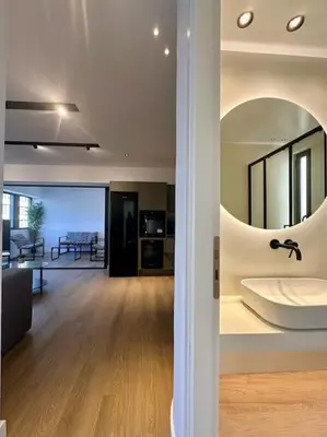a living room with a large mirror on the wall at BlueMotion - CruiseHub 3B in Piraeus