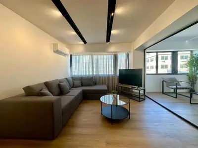 a living room with a couch and a television at BlueMotion - CruiseHub 3B in Piraeus