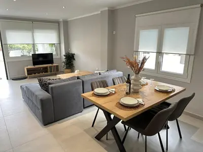 a living room with a table and a couch at Seaside Luxury Apartments in Porto Rafti