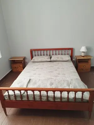 a bedroom with a bed with two nightstands and two tables at Recreation rooms in Athens