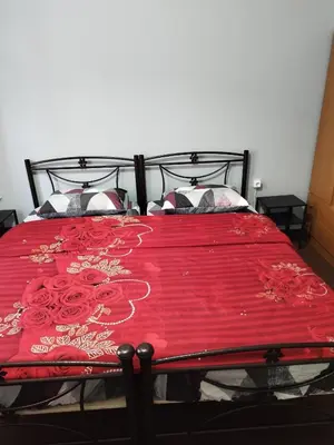 a red bed with a red blanket on it at Recreation rooms in Athens