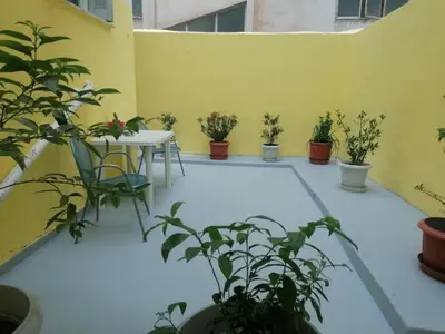 a patio with a table and potted plants at Recreation rooms in Athens