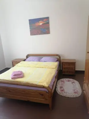 a bedroom with a bed and a painting on the wall at Recreation rooms in Athens