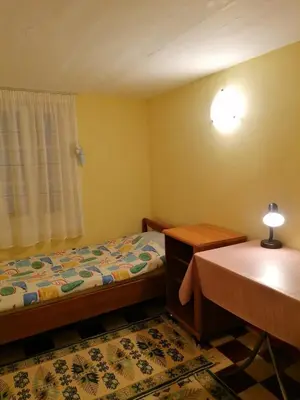 a bedroom with a bed and a desk and a table at Комнаты отдыха in Athens