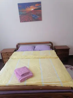 a bed with two towels on top of it at Комнаты отдыха in Athens