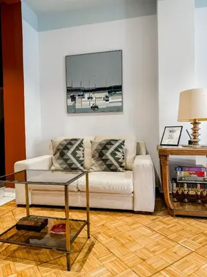 a living room with a couch and a table at Apartment near Metro + Port in Piraeus