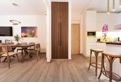 a kitchen and dining room with a table and chairs at Artsy Spacious Cozy Apartment in Glyfada Center in Athens