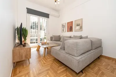 a living room with a couch and a table at Athenian Gem, Fully Renovated 2 Bedroom Apartment Near Acropolis in Athens
