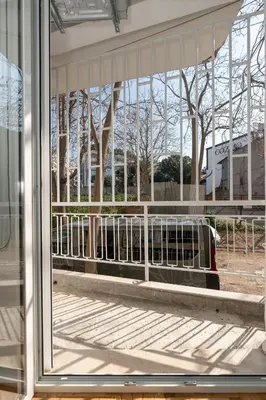 a window in a building looking out at a bus at Athenian Gem, Fully Renovated 2 Bedroom Apartment Near Acropolis in Athens