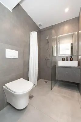 a bathroom with a toilet and a sink at Athenian Gem, Fully Renovated 2 Bedroom Apartment Near Acropolis in Athens