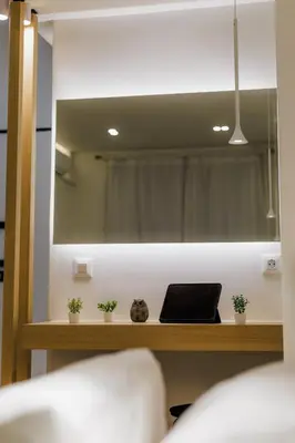 a mirror above a table with a laptop on it at Modern & Stylish 1 BDR Apartment in Athens