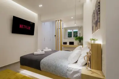 a bedroom with a king sized bed in a room at Modern & Stylish 1 BDR Apartment in Athens