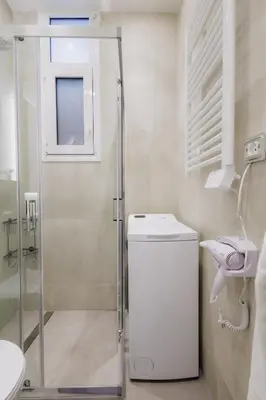 a bathroom with a shower and a toilet and a sink at Modern & Stylish 1 BDR Apartment in Athens