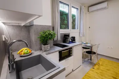 a kitchen with a sink and a bowl of fruit on the counter at Modern & Stylish 1 BDR Apartment in Athens