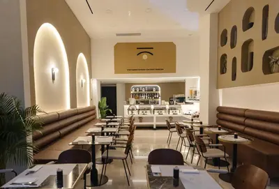a restaurant with tables and chairs and a counter at Esse Athens in Athens
