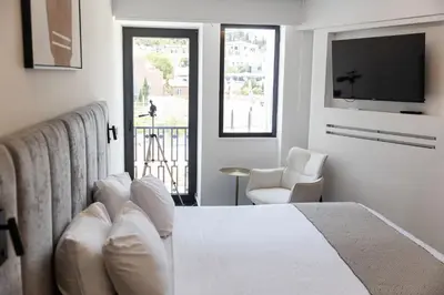 a hotel room with a bed and a television at Esse Athens in Athens