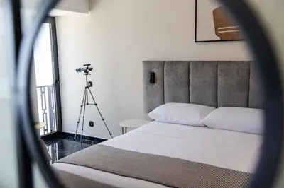 a bedroom with a bed and a camera on a tripod at Esse Athens in Athens