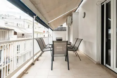 a balcony with a table and chairs on it at YestayHomes Two Bedroom Apartment Tsakalof in Athens