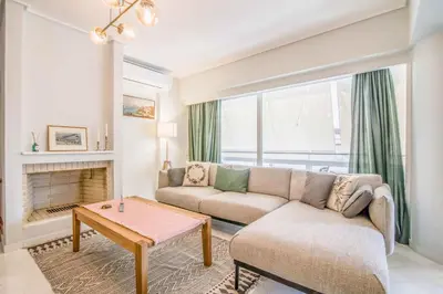 a living room with a couch and a table at The Urban Utopia at Glyfada in Athens