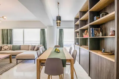 a living room with a table and a couch at The Urban Utopia at Glyfada in Athens