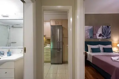a kitchen and a bedroom with a bed and a sink at Blue Ark Exploring Athens in Athens