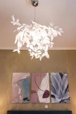 a chandelier hanging from a ceiling with three pictures at Blue Ark Exploring Athens in Athens